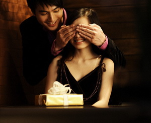 Man Surprising Woman with Gift